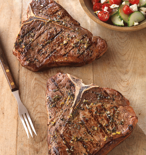 Greek-Seasoned T-Bone Steaks with Cucumber and Tomato Salad